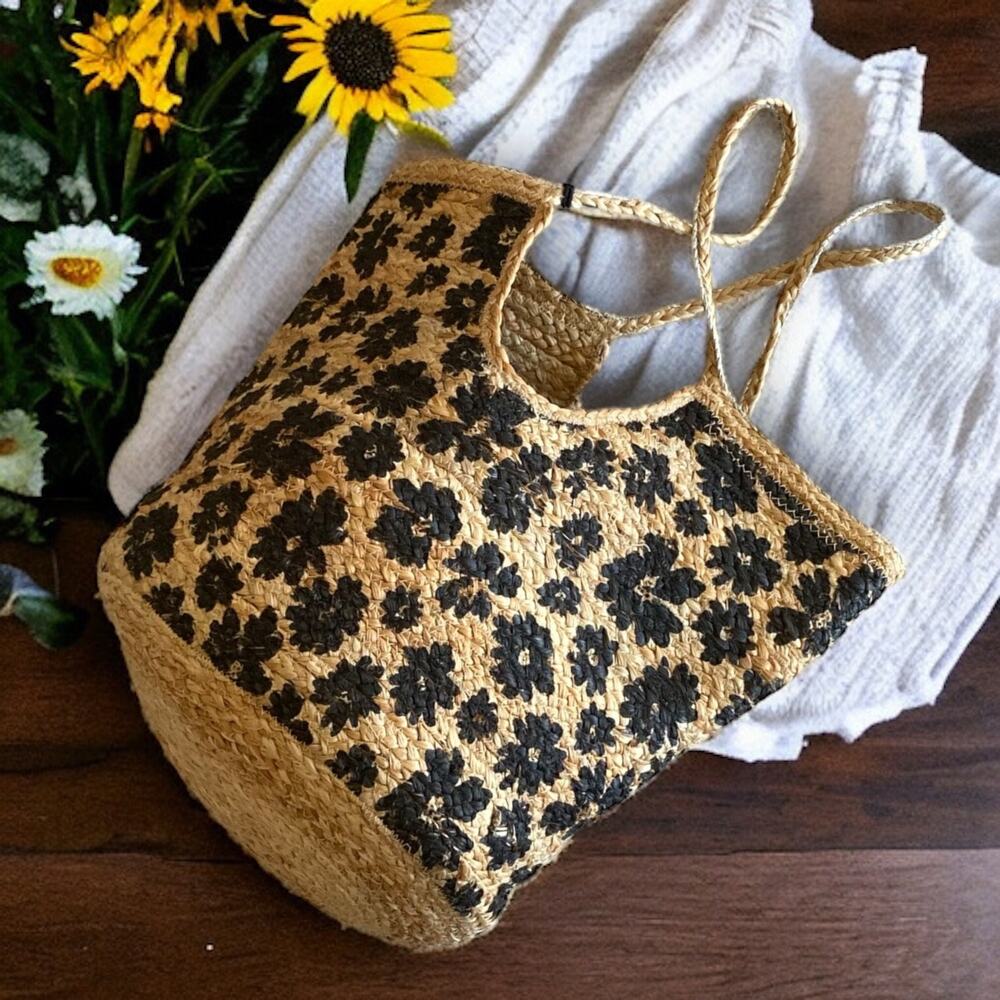 Woven straw beach bag with black floral print